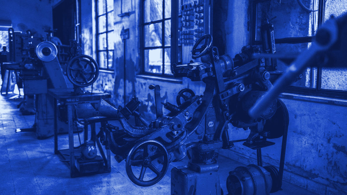 Disused machinery in an empty industrial workshop