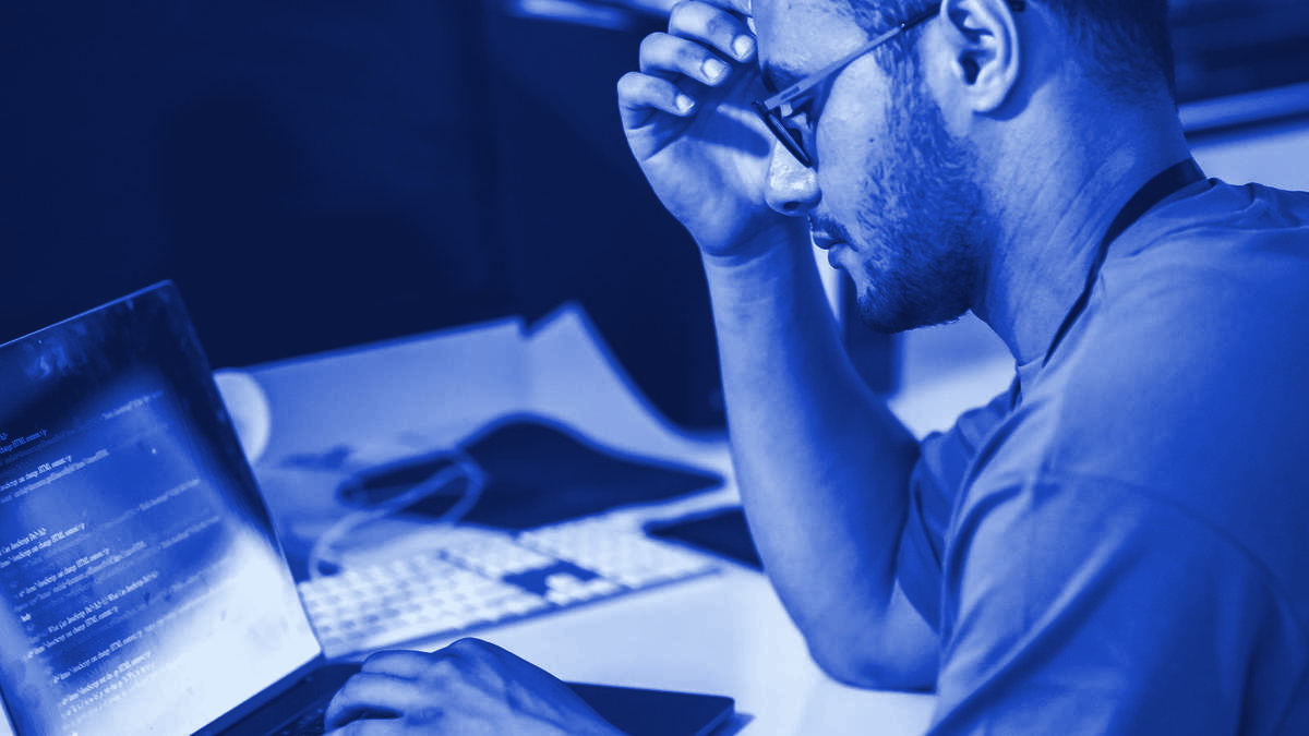 A developer focused on code at a desk