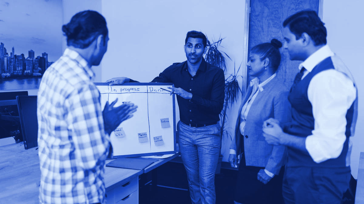 A team reviewing work together in a meeting