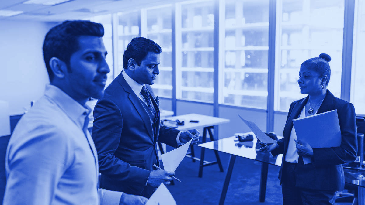 Colleagues reviewing documents together in an office